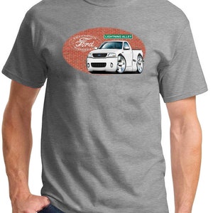 May include: A gray t-shirt with a white Ford Lightning pickup truck illustration. The truck is on a brick background with the text "The Famous Ford Store" and "Lightning Alley".