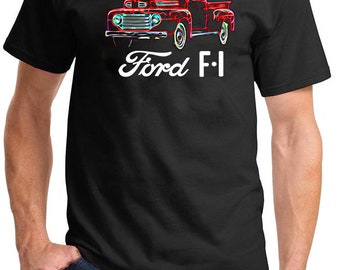 May include: A black t-shirt with a white graphic of a red Ford F-1 pickup truck. The truck is outlined in neon colors.