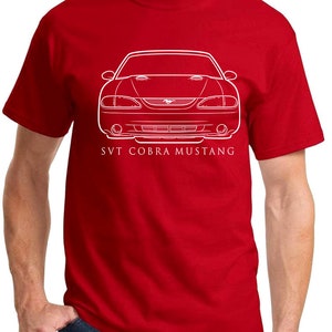 May include: A red t-shirt featuring a white outline of a Ford Mustang SVT Cobra. The text "SVT Cobra Mustang" is printed below the car.