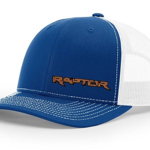 May include: A blue and white trucker hat with a brown embroidered "RAPTOR" logo.