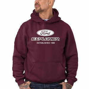 May include: Burgundy hooded sweatshirt with a white Ford Explorer logo and the text "Established 1990".