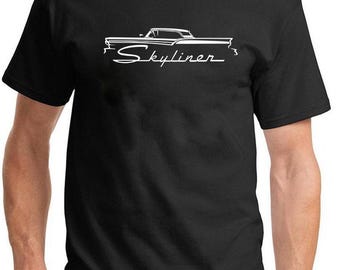 May include: Black t-shirt featuring a white graphic of a classic car with the word "Skyliner" in a cursive font. The design is centered on the front of the shirt. The shirt has a crew neck and short sleeves.