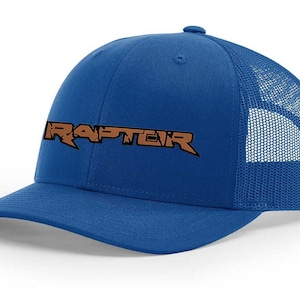 May include: A royal blue trucker hat with a brown embroidered "RAPTEIR" logo.