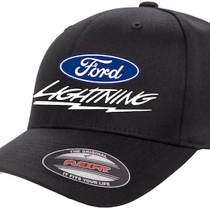May include: Black baseball cap with a blue oval Ford logo and white "Lightning" text with a lightning bolt graphic. The cap has a Flexfit label on the underside of the brim.