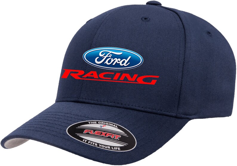 May include: A navy blue baseball cap with a white Ford Racing logo. The logo has a blue oval with the word "Ford" in white and the word "Racing" in red below the oval. The cap has a Flexfit label on the back.