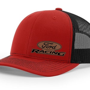 May include: Red and black trucker hat with the Ford Racing logo. The hat features a red front panel and brim, with a black mesh back. The Ford Racing logo is embroidered on the front in brown and black.