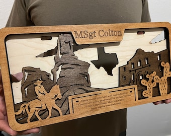May include: A wooden plaque with a cutout design of the state of Texas, the Alamo, and a cowboy riding a horse. The plaque is personalized with the text "MSgt Colton" and a message of thanks for service and leadership.
