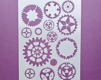 May include: White plastic stencil with the text "MILARTES" and "Sg134" at the top. The stencil features a design of various sized gears and a star.