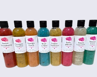 May include: Eight clear plastic bottles of Yoni Wash with black flip-top caps, each containing 8 oz | 220 g of colorful gel with visible botanical particles. Labels feature the brand name Best Bee Love and scents: Sweet Strawberry, Pineapple Paradise, Georgia Peach, Wait A Mint, Golden Sunflower, Baby pHresh, Simply Unscented, and Island Love.
