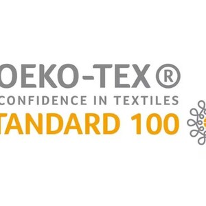 May include: The image displays the Oeko-Tex Standard 100 logo. The text includes "OEKO-TEX" in gray, "CONFIDENCE IN TEXTILES" in gray, and "STANDARD 100" in orange. A decorative emblem is on the right.