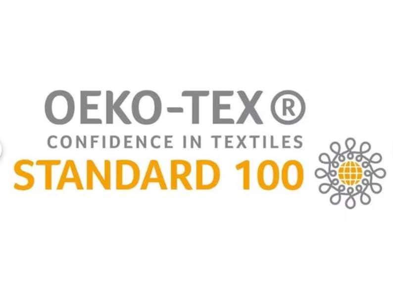 May include: The image displays the Oeko-Tex Standard 100 logo. The text includes "OEKO-TEX" in gray, "CONFIDENCE IN TEXTILES" in gray, and "STANDARD 100" in orange. A decorative emblem is on the right.