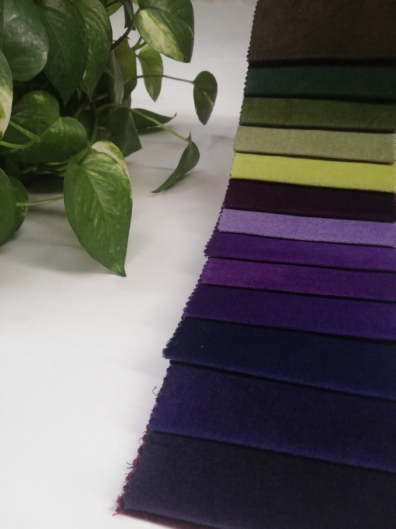 May include: A collection of fabric swatches in various shades of green, purple, and blue. The swatches are arranged in a gradient from light to dark.