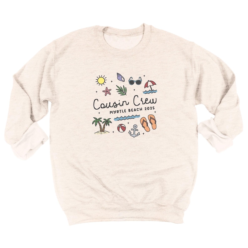 K&ouml;nnte beinhalten: Ein hellbeige Sweatshirt mit langen &Auml;rmeln. Auf der Vorderseite befindet sich eine farbenfrohe Grafik mit dem Text "Cousin Crew Myrtle Beach 2025", umgeben von Strandmotiven wie Sonne, Palmen und Flip-Flops.