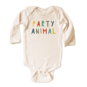 May include: A long-sleeve cream-colored baby bodysuit featuring the text PARTY ANIMAL printed in a multi-colored sans-serif font across the chest. The garment has a crew neckline and a snap-button closure at the bottom for easy access.