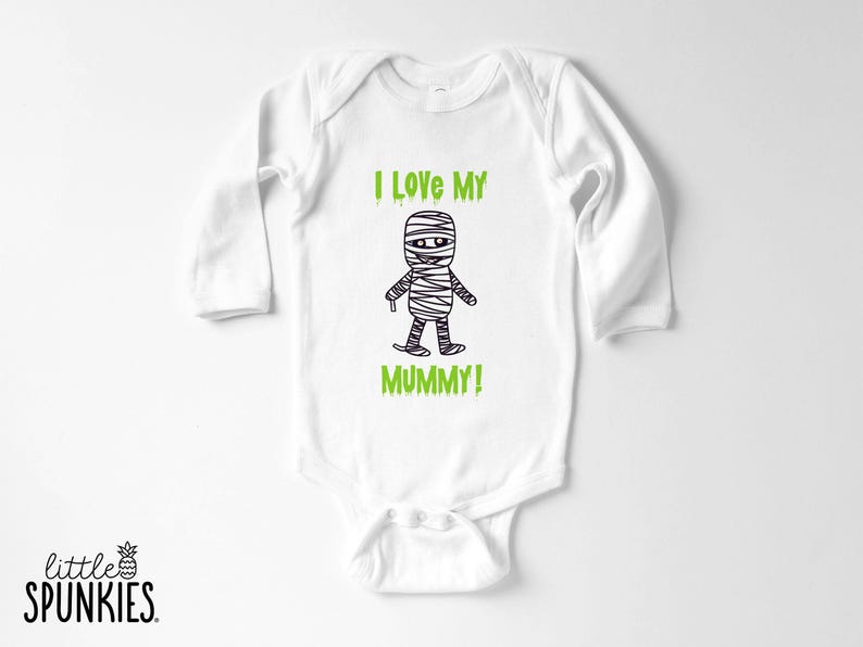 May include: A white long-sleeve baby bodysuit featuring a black line-art illustration of a mummy character centered on the chest. Above and below the mummy, the text reads I LOVE MY MUMMY! in a bright green, dripping-style font.
