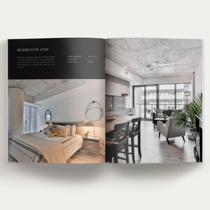 K&ouml;nnte beinhalten: Ein aufgeschlagenes Buch mit Innenarchitektur-Fotografien. Die linke Seite zeigt ein Schlafzimmer mit Bett, Nachttisch und Spiegel. Die rechte Seite zeigt einen Wohnbereich mit K&uuml;che, Esstisch und St&uuml;hlen. Text enth&auml;lt BEDROOM ONE.