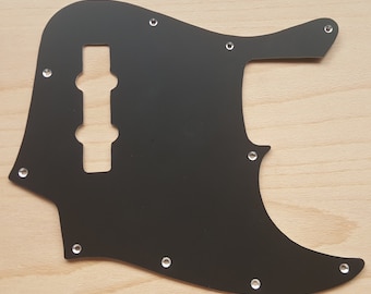 Compatible con Squier Jazz Bass. Golpeador en aluminio anodizado negro, dorado o satinado. Opción de grabado a mano.