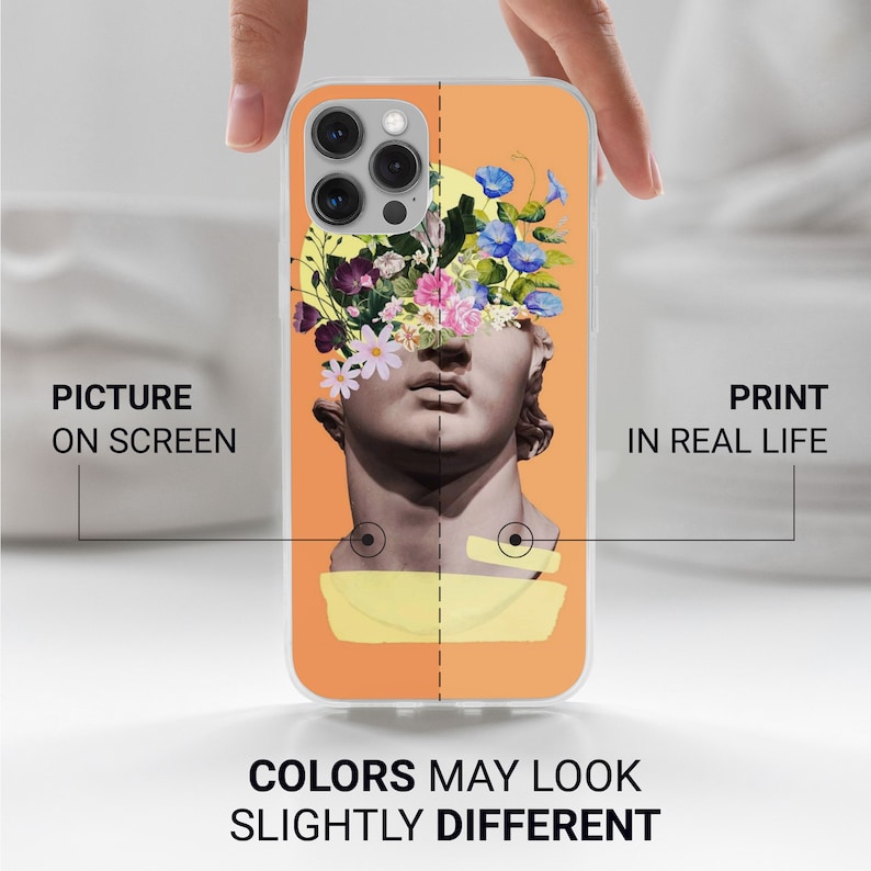 May include: A clear phone case with a design of a sculpture with flowers on top of its head. The background is orange. The text "PRINT IN REAL LIFE" is on the right side of the image. The text "PICTURE ON SCREEN" is on the left side of the image. The text "COLORS MAY LOOK SLIGHTLY DIFFERENT" is at the bottom of the image.