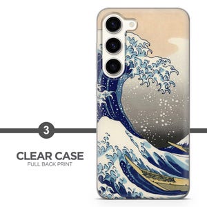 May include: A clear smartphone case featuring a full back print of a large, stylized blue ocean wave with white foam crests and small boats, set against a pale beige background. The case has three circular camera lens cutouts on the upper left side.
