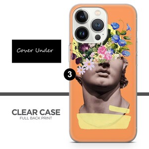 May include: A clear phone case with a full back print of a sculpture with flowers growing out of its head. The background is orange.