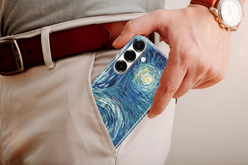 May include: A smartphone case featuring a reproduction of the Starry Night painting with swirling blue, yellow, and white brushstroke patterns. The case has three circular camera lens cutouts at the top and is partially inserted into a pocket.