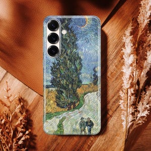 May include: A rectangular smartphone case featuring a printed reproduction of Vincent van Gogh's Wheat Field with Cypresses painting. The design displays a tall dark green cypress tree, a golden wheat field, and a swirling blue sky with a crescent moon.