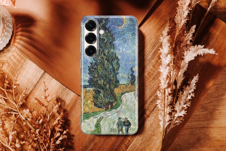 May include: A rectangular smartphone case featuring a printed reproduction of Vincent van Gogh's Wheat Field with Cypresses painting. The design displays a tall dark green cypress tree, a golden wheat field, and a swirling blue sky with a crescent moon.