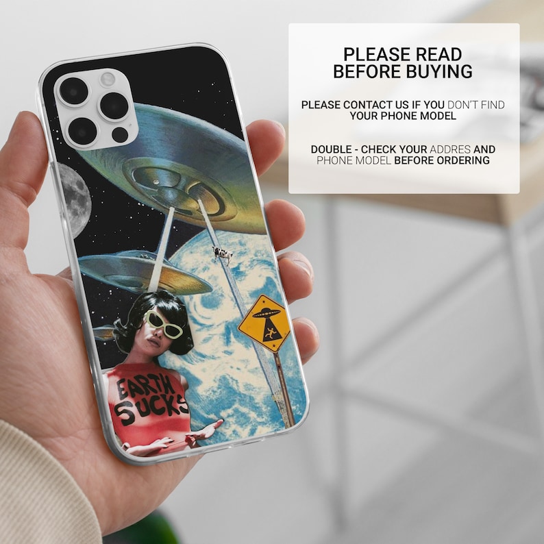 May include: A clear phone case with a colorful collage design featuring a woman wearing sunglasses and a shirt that says "Earth Sucks". The background is a space scene with flying saucers and a planet.