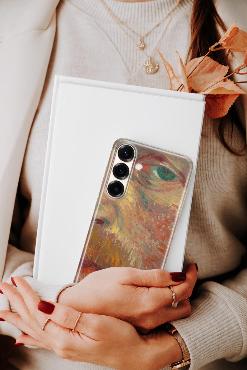 May include: A smartphone case featuring a vibrant, textured impressionist-style painting of a human eye with warm tones of orange, yellow, and brown, contrasted by a green iris. The case has a vertical triple-lens camera cutout on the upper left.