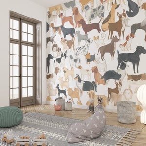 May include: A white wall with a wallpaper featuring a pattern of various breeds of dogs in different poses. The dogs are illustrated in a cartoon style with watercolor-like textures. The wallpaper is in a room with a rug, a beanbag chair, and a lamp.