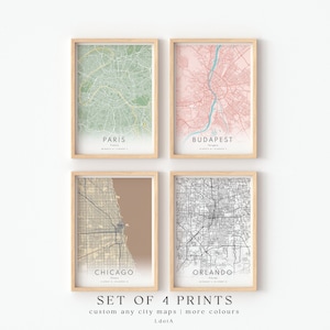 May include: Set of four city map prints in frames. The maps are of Paris, Budapest, Chicago, and Orlando. The maps are in different colors, including green, pink, brown, and black and white.