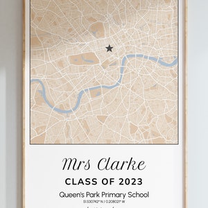 May include: Framed map print featuring a detailed beige and white city map with a blue river. The text reads "Mrs Clarke CLASS OF 2023" and "Queen's Park Primary School". A black star marks a location. The words "best teacher" and "ghost" are also present.