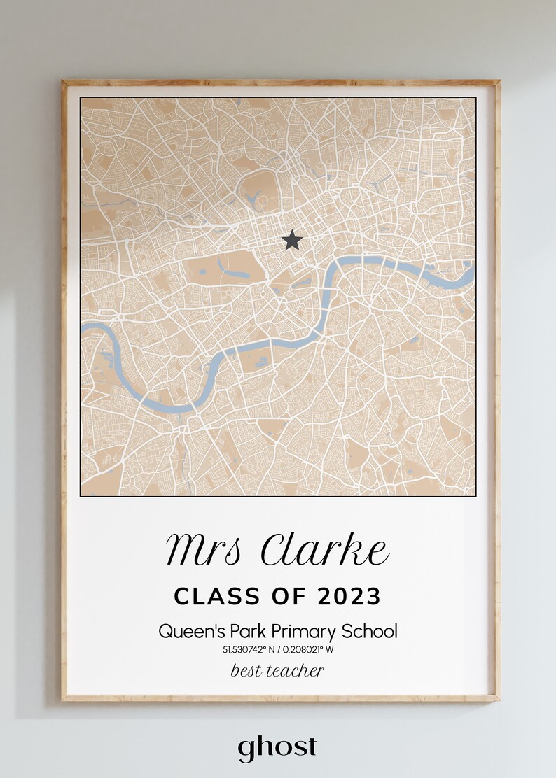 May include: Framed map print featuring a detailed beige and white city map with a blue river. The text reads "Mrs Clarke CLASS OF 2023" and "Queen's Park Primary School". A black star marks a location. The words "best teacher" and "ghost" are also present.