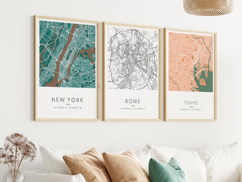 May include: Three framed city maps with a white background. The maps are of New York City in teal and brown, Rome in black and white, and Tokyo in peach and green.