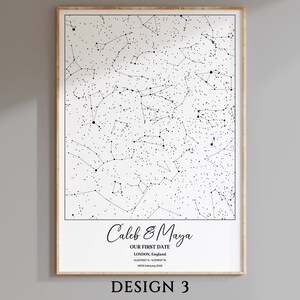 May include: A black and white star map print with the text "Caleb & Maya", "OUR FIRST DATE", "LONDON, England", "51.507225&deg; N / 0.1275&deg; W", and "26 February 2003".