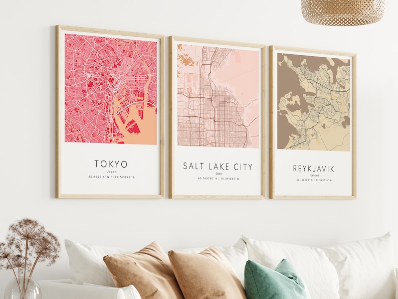 May include: Three framed city maps with a pink, beige, and brown color scheme. The maps are labeled "Tokyo, Japan", "Salt Lake City, Utah", and "Reykjavik, Iceland".