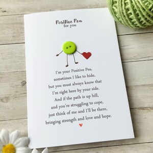 May include: A white card with a green button and a red heart, with the text "Positive Pea for you" and a poem about being there for someone when they need it.