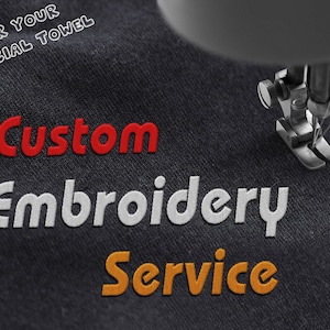 May include: Close-up of a sewing machine embroidering the words "Custom Embroidery Service" on a dark gray fabric. The words are in red, white, and orange thread.
