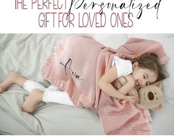 May include: A pink personalized baby blanket with the name "Ava" embroidered on it. The blanket is made of soft, breathable fabric and is perfect for cuddling. The blanket is shown on a bed with a child holding a stuffed animal.