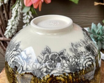 Handmade ceramic bowl with flower design and drip glaze