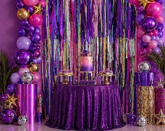 May include: A party scene with a purple and pink theme. A round table covered in a sequined purple tablecloth holds a cake and cupcakes. Balloons, disco balls, and star decorations are arranged around the table. A shimmering curtain backdrop adds to the festive atmosphere.