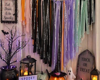 May include: Halloween decorations featuring a lit jack-o'-lantern wearing a witch hat, a tombstone that reads "Trick or Treat", and a sign that says "Spooky Vibes Only". The scene includes pumpkins, a ghost, and hanging streamers.