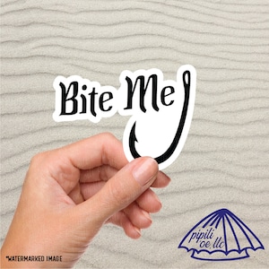 May include: White sticker with black text that says "Bite Me" and a black fishing hook.
