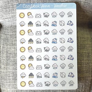 May include: A rectangular sticker sheet titled CozyBookSleeve - Weather featuring rows of small, colorful, cartoon-style weather icons. The designs include smiling suns, clouds, moons, rain, snow, wind, and lightning bolts in various shades of yellow, blue, and gray.