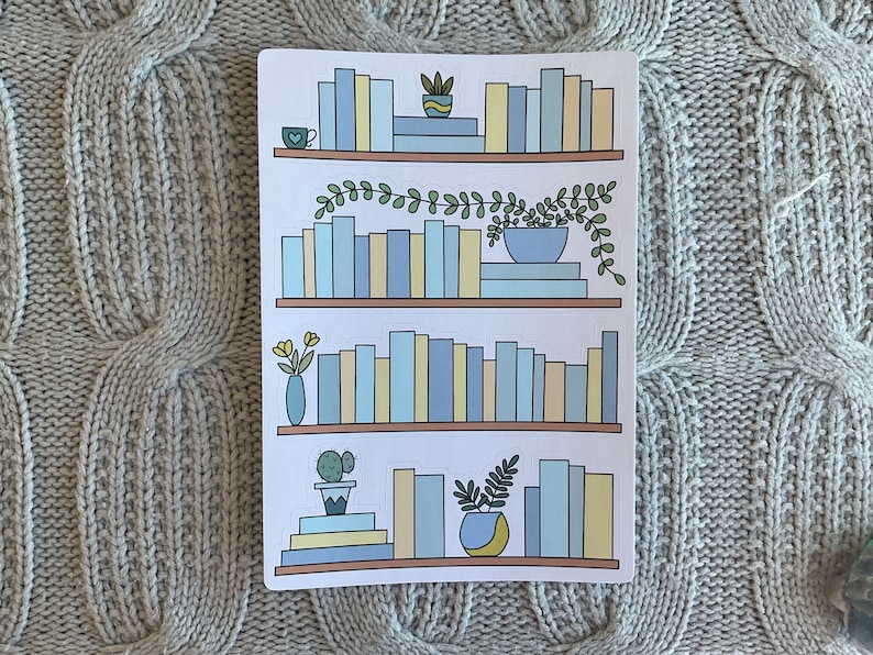May include: A white sticker sheet with four illustrations of bookshelves. Each bookshelf is filled with blue and yellow books and decorated with plants and a small cup of coffee.