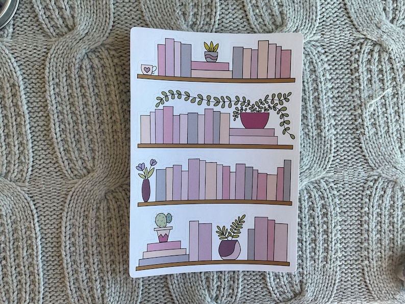 May include: A digital illustration of a bookshelf with four shelves filled with pink and purple books. Each shelf has a small plant or flower arrangement on it.