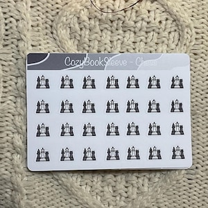 May include: A sheet of stickers with a chess theme. The stickers feature a black and white chess piece design. The text "CozyBookSleeve - Chess" is printed at the top of the sheet. The stickers are on a white background.