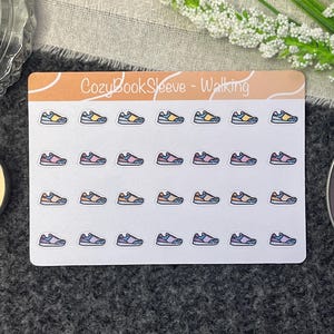 May include: A sheet of colourful walking shoe stickers with the text "CozyBookSleeve - Walking" at the top. The stickers are arranged in rows of five.