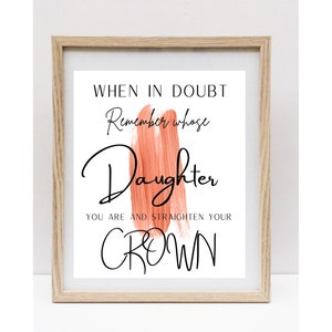 May include: A framed print with a peach-coloured brushstroke and the text "When in doubt remember whose daughter you are and straighten your crown."