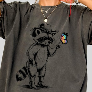 Funny Raccoon T-Shirt, Funny Cowgirl Shirt, Cute Raccoon Shirt, Nature Lover Gift, Fun Graphic Tee, Funny Pet T-shirt, Butterfly Shirt
